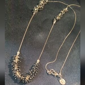 Elegant Gold Necklace with Long Chain and Textured Dangling Elements